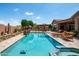 Beautiful backyard pool with a spa, lounge chairs, outdoor seating, and an outdoor grilling area perfect for entertaining at 42037 N Bradon Way, Phoenix, AZ 85086