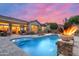 Backyard pool featuring a waterfall, fire features, lounge chairs, and a peek into the dining area at 42037 N Bradon Way, Phoenix, AZ 85086