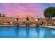 Inviting backyard pool featuring decorative water features, lush desert landscaping, and captivating sunset views at 42037 N Bradon Way, Phoenix, AZ 85086