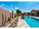 The backyard showcases a beautiful pool with spa and desert landscaping, ideal for relaxation and outdoor enjoyment at 42037 N Bradon Way, Phoenix, AZ 85086