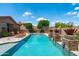 Sparkling backyard pool and spa surrounded by desert landscaping and lounge chairs, perfect for relaxing and enjoying the outdoors at 42037 N Bradon Way, Phoenix, AZ 85086
