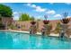 Backyard pool with desert landscaping and an eye-catching design creates a serene outdoor oasis for relaxation and enjoyment at 42037 N Bradon Way, Phoenix, AZ 85086