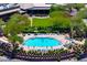 Aerial view of a community pool with clear blue water surrounded by lounge chairs and desert landscaping at 42037 N Bradon Way, Phoenix, AZ 85086
