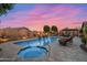 Inviting backyard pool and spa with an outdoor fireplace and pergola seating area for entertaining at 42037 N Bradon Way, Phoenix, AZ 85086