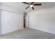 Neutral bedroom with closet doors, neutral carpeting, and open doorway to the rest of the house at 4206 N 38Th St # 1, Phoenix, AZ 85018