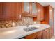 Updated kitchen boasts quartz countertops, stainless steel sink, and mosaic tile backsplash at 4206 N 38Th St # 1, Phoenix, AZ 85018