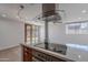 Eat-in kitchen with island, quartz countertop, and stainless steel range hood at 4206 N 38Th St # 1, Phoenix, AZ 85018