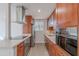 Galley kitchen with stainless steel appliances, ample cabinetry, and clean, modern finishes at 4206 N 38Th St # 1, Phoenix, AZ 85018