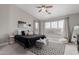 This bedroom features a ceiling fan, a large window, and a gray and black rug at 4292 E Terrace Ave, Gilbert, AZ 85234