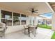 Covered patio featuring a ceiling fan, outdoor dining area, and views of the backyard and pool at 4292 E Terrace Ave, Gilbert, AZ 85234