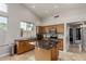 Bright kitchen boasting stone counters, stainless appliances, a central island, and tiled flooring at 4292 E Terrace Ave, Gilbert, AZ 85234