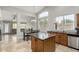 Well-lit kitchen with a central island, stone counters, and views of the dining area and backyard at 4292 E Terrace Ave, Gilbert, AZ 85234
