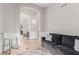 Inviting living room featuring an arched hallway and comfortable gray couch with plush pillows at 4292 E Terrace Ave, Gilbert, AZ 85234