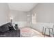 Cozy living room area with gray couch and patterned rug, complemented by natural light from nearby windows at 4292 E Terrace Ave, Gilbert, AZ 85234