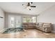 The living room features a ceiling fan, a large sectional couch, and a view to the backyard at 4292 E Terrace Ave, Gilbert, AZ 85234