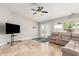 The living room features a ceiling fan, a large sectional couch, and a TV at 4292 E Terrace Ave, Gilbert, AZ 85234