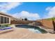 Inviting backyard pool with rock features, surrounded by a patio, lush landscaping, and lounge chairs at 4292 E Terrace Ave, Gilbert, AZ 85234