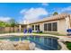 Scenic pool area featuring a rock waterfall, surrounded by a patio, lush landscaping, and a well-maintained lawn at 4292 E Terrace Ave, Gilbert, AZ 85234