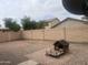 Spacious backyard with stone landscaping and a dog house at 43845 W Elizabeth Ave, Maricopa, AZ 85138