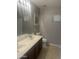 Bathroom features a double sink vanity, large mirror, and a framed picture at 43845 W Elizabeth Ave, Maricopa, AZ 85138