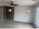 Neutral bedroom with carpeted floors, a ceiling fan, and large windows at 43845 W Elizabeth Ave, Maricopa, AZ 85138