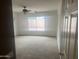 Bright bedroom with a ceiling fan and a large window overlooking the backyard at 43845 W Elizabeth Ave, Maricopa, AZ 85138