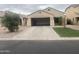 Beige single Gathering home with a spacious driveway leading to the attached garage at 43845 W Elizabeth Ave, Maricopa, AZ 85138