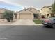 Charming single-story home with a two-car garage and well-maintained front yard at 43845 W Elizabeth Ave, Maricopa, AZ 85138
