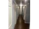 Hallway with tile floors and neutral walls connecting different areas of the house at 43845 W Elizabeth Ave, Maricopa, AZ 85138