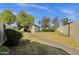 Well-maintained backyard with lush lawn, walkway, and mature trees, offering a serene outdoor retreat at 4549 W Mclellan Rd, Glendale, AZ 85301