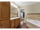 Inviting bathroom with a soaking tub, tiled walls, and modern fixtures at 4549 W Mclellan Rd, Glendale, AZ 85301