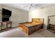 Cozy bedroom with neutral walls, carpet flooring, and a unique wooden bed frame at 4549 W Mclellan Rd, Glendale, AZ 85301