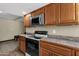 Functional kitchen space with a microwave, range, and tiled flooring at 4549 W Mclellan Rd, Glendale, AZ 85301