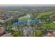 Stunning aerial view of community featuring lush green landscape, water features, and manicured grounds at 46185 W Dutchman Dr, Maricopa, AZ 85139