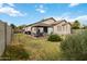 Spacious backyard showcasing a gazebo with outdoor furniture, lush greenery and desert landscaping at 46185 W Dutchman Dr, Maricopa, AZ 85139