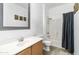 Bright bathroom with a shower-tub combination, white vanity and decorative accents for a clean, modern feel at 46185 W Dutchman Dr, Maricopa, AZ 85139