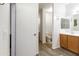 Bright bathroom with wood-look flooring, stylish vanity, and modern fixtures at 46185 W Dutchman Dr, Maricopa, AZ 85139