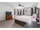 Comfortable bedroom with natural light, a ceiling fan, and ample space for relaxation at 46185 W Dutchman Dr, Maricopa, AZ 85139