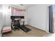 Bedroom featuring a dedicated workspace with desk setup, treadmill and comfortable chair at 46185 W Dutchman Dr, Maricopa, AZ 85139