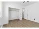 Clean bedroom featuring wood-look floors, closet, neutral walls and an airy, spacious feel at 46185 W Dutchman Dr, Maricopa, AZ 85139