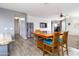 Inviting dining room with a wooden table and chairs, seamlessly blending with the kitchen and living spaces at 46185 W Dutchman Dr, Maricopa, AZ 85139