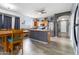 Open concept kitchen with stainless steel appliances, wood cabinets, wood look floors and bar seating at 46185 W Dutchman Dr, Maricopa, AZ 85139