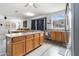 Open concept kitchen with a large island, wood cabinets, and stainless steel appliances at 46185 W Dutchman Dr, Maricopa, AZ 85139