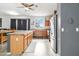 Well-appointed kitchen with ample counter space, stainless steel refrigerator and view of outdoor neighborhood at 46185 W Dutchman Dr, Maricopa, AZ 85139