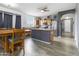 Modern kitchen featuring an island, stainless steel appliances, and a dining area with natural light at 46185 W Dutchman Dr, Maricopa, AZ 85139