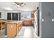 Well-appointed kitchen with ample counter space, stainless steel refrigerator and view of outdoor neighborhood at 46185 W Dutchman Dr, Maricopa, AZ 85139