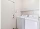 Practical laundry room with washer, dryer, and convenient shelving at 46185 W Dutchman Dr, Maricopa, AZ 85139