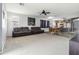 Spacious living area features plush carpeting and comfortable seating arrangement and an open kitchen area at 46185 W Dutchman Dr, Maricopa, AZ 85139