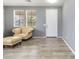 Inviting living room featuring neutral tones, two windows, and an elegant tan leather chair at 46185 W Dutchman Dr, Maricopa, AZ 85139