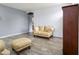 Open living room with hard flooring and comfortable tan leather furniture, well lit with neutral paint at 46185 W Dutchman Dr, Maricopa, AZ 85139